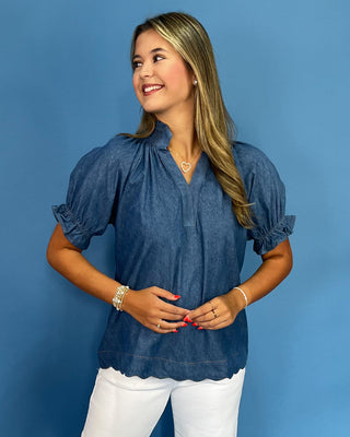 Woman wearing a blue blouse against a blue background