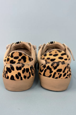 Pair of leopard print sneakers on a light gray background