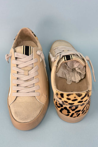 Pair of beige sneakers with leopard print accents on a light gray background