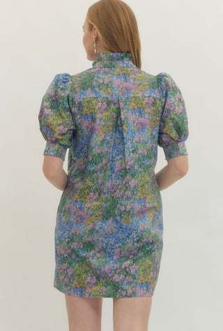 Woman wearing a floral dress with puff sleeves on a white background