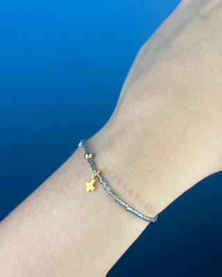 Shop the Enewton Hope Classic Signature Cross Morning Mist Bracelet featuring iridescent gray glass beads and a delicate gold cross charm.