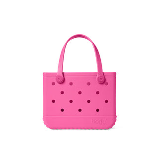 Pink handbag with black polka dots on a white background