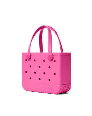 Pink handbag with polka dot pattern on a white background