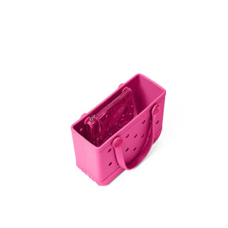 Pink handbag with clear plastic lining on a white background