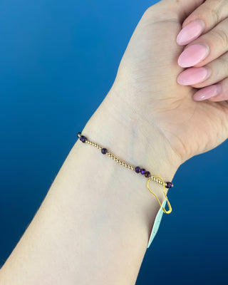 Shop the Enewton Gameday Flirty Hope Unwritten Purple Bracelet featuring polished gold beads and sparkling purple accents. Perfect for game day and everyday!