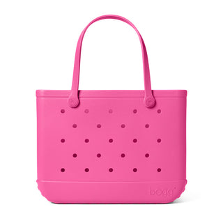 Pink tote bag with polka dot pattern on a white background