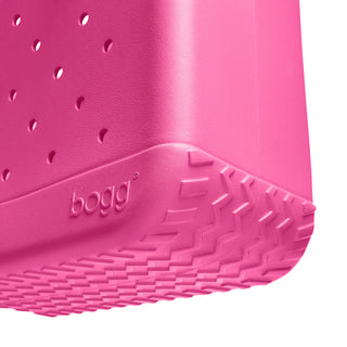 Close-up of a pink rubber shoe sole with 'bogg' branding on a white background