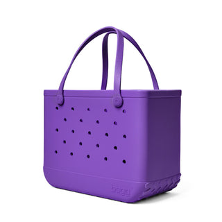 Purple tote bag with perforated design on a white background