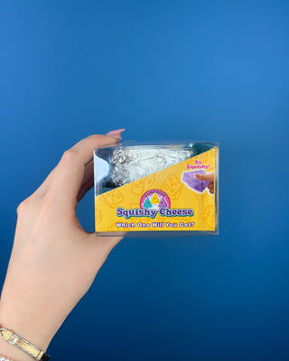 Shop the Surprise Squishy Cheese mystery toy! Discover a fun foil-wrapped collectible squishy, perfect for Easter baskets, stocking stuffers, and gifts.