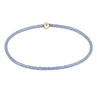 Delicate purple beaded necklace with a gold clasp on a white background