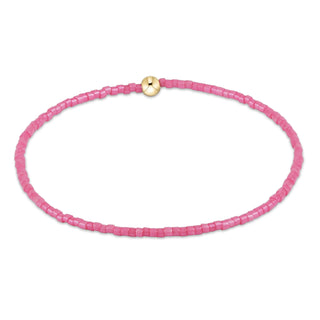 Pink beaded necklace with a gold clasp on a white background