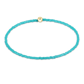 Turquoise beaded choker necklace with a gold clasp on a white background