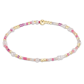 Necklace with pink, white, and gold beads on a white background