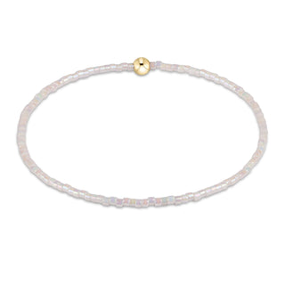 Delicate bracelet with small beads and a gold clasp on a white background