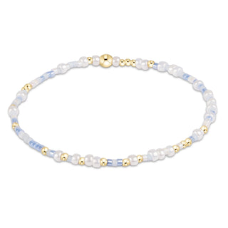 Bracelet with pearls and gold beads on a white background