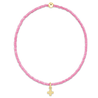 Pink beaded necklace with a gold cross pendant on a white background