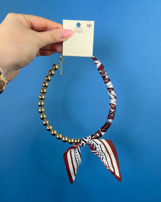 Shop the Half Beaded Scarf Necklace in multiple colors! Features polished gold-tone beads, patterned scarf details, and a sty