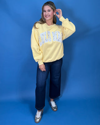 Lulu Mac Buttercream Camo Varsity Crewneck featuring a cozy fleece-lined interior, oversized camouflage varsity applique, relaxed fit, and classic collegiate style