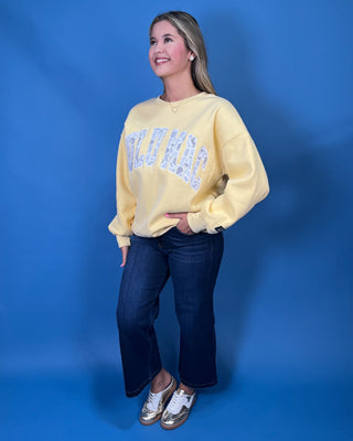 Lulu Mac Buttercream Camo Varsity Crewneck featuring a cozy fleece-lined interior, oversized camouflage varsity applique, relaxed fit, and classic collegiate style