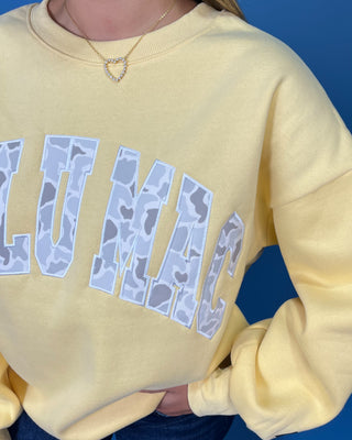 Lulu Mac Buttercream Camo Varsity Crewneck featuring a cozy fleece-lined interior, oversized camouflage varsity applique, relaxed fit, and classic collegiate style