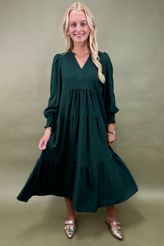 Woman wearing a green dress against a green background