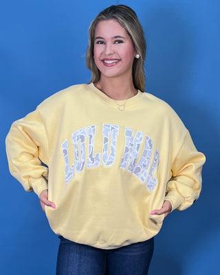 Lulu Mac Buttercream Camo Varsity Crewneck featuring a cozy fleece-lined interior, oversized camouflage varsity applique, relaxed fit, and classic collegiate style