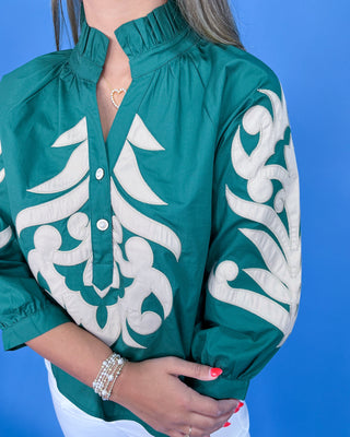 Green jacket with white patterns on a blue background