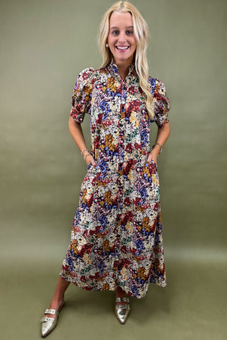 Woman wearing a floral dress against a green background