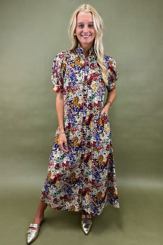 Woman wearing a floral dress against a green background