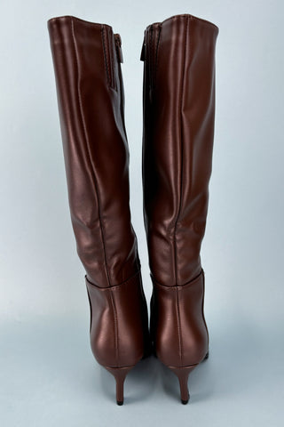 Pair of brown knee-high boots on a light gray background