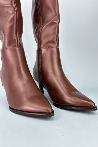 Pair of brown knee-high boots on a light gray background