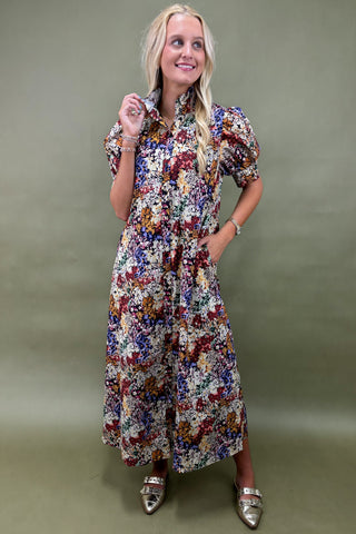 Woman wearing a floral dress against a green background