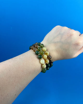 Shop the Olive Multi-Colored Beads Bracelet Set featuring glossy green, brown, and cream marbled beads with gold-tone accents for effortless everyday style.