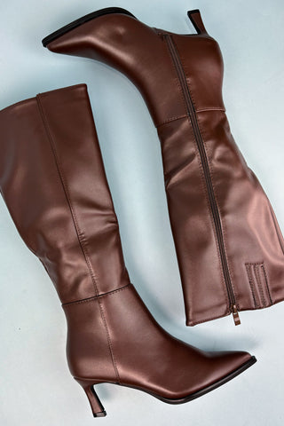 Brown leather knee-high boots on a light gray background