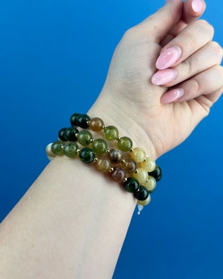 Shop the Olive Multi-Colored Beads Bracelet Set featuring glossy green, brown, and cream marbled beads with gold-tone accents for effortless everyday style.