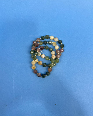 Shop the Olive Multi-Colored Beads Bracelet Set featuring glossy green, brown, and cream marbled beads with gold-tone accents for effortless everyday style.