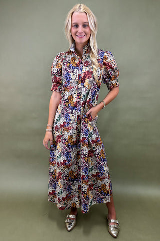 Woman wearing a floral dress against a green background