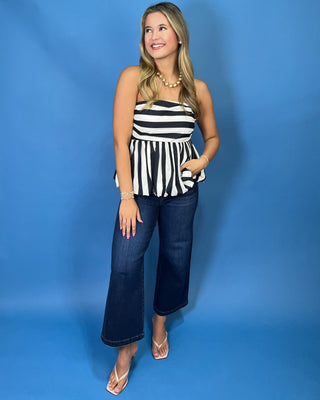 black and white striped strapless bubble hem top with a ruched bodice and flattering fit.