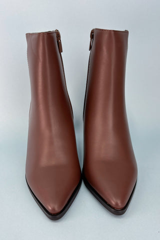 Pair of brown leather ankle boots on a white background