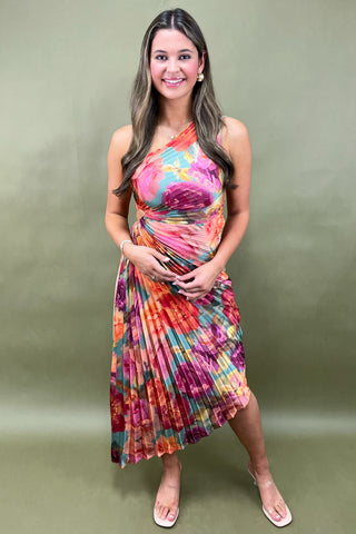 Woman wearing a colorful dress against a green background