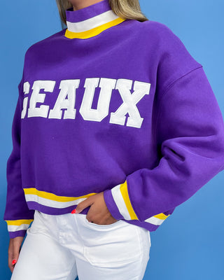 Purple sweatshirt with 'GEAUX' text on a blue background
