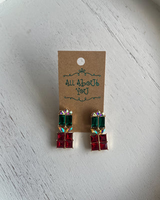 Christmas Present Earrings featuring sparkling red and green rhinestones, iridescent bows, and gold accents.