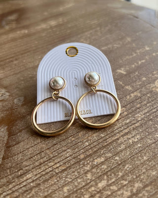 Shop the Eden Pearl Matte Gold Earrings featuring elegant pearl studs and open-circle gold drops. Perfect for everyday outfits, weddings, and special occasions.