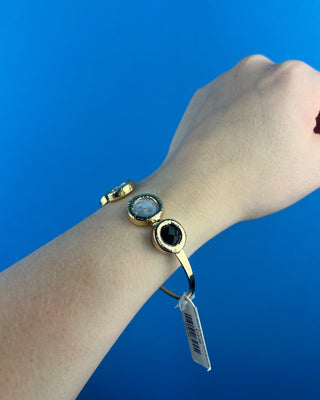 Shop the Claire Black & White Cuff Bracelet featuring glossy black stones, perl-inspired accents, and textured gold details for elegant everyday style.