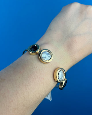 Shop the Claire Black & White Cuff Bracelet featuring glossy black stones, perl-inspired accents, and textured gold details for elegant everyday style.