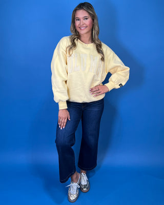 Butter yellow Lulu Mac graphic crewneck sweatshirt with tonal varsity-style lettering, long sleeves, ribbed trim, and a relaxed fit.