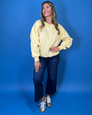 Butter yellow Lulu Mac graphic crewneck sweatshirt with tonal varsity-style lettering, long sleeves, ribbed trim, and a relaxed fit.