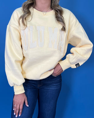 Butter yellow Lulu Mac graphic crewneck sweatshirt with tonal varsity-style lettering, long sleeves, ribbed trim, and a relaxed fit.