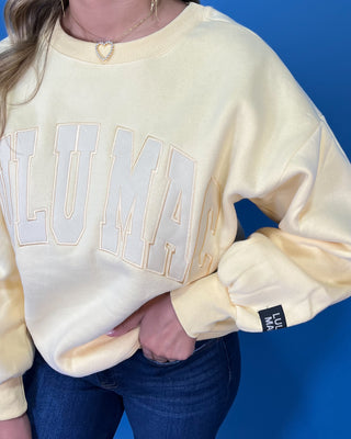 Butter yellow Lulu Mac graphic crewneck sweatshirt with tonal varsity-style lettering, long sleeves, ribbed trim, and a relaxed fit.