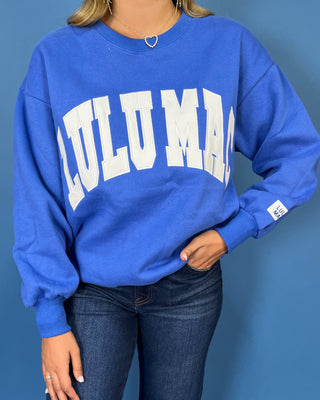 Royal blue Lulu Mac graphic crewneck sweatshirt with bold white varsity lettering, long sleeves, ribbed trim, and a relaxed fit.